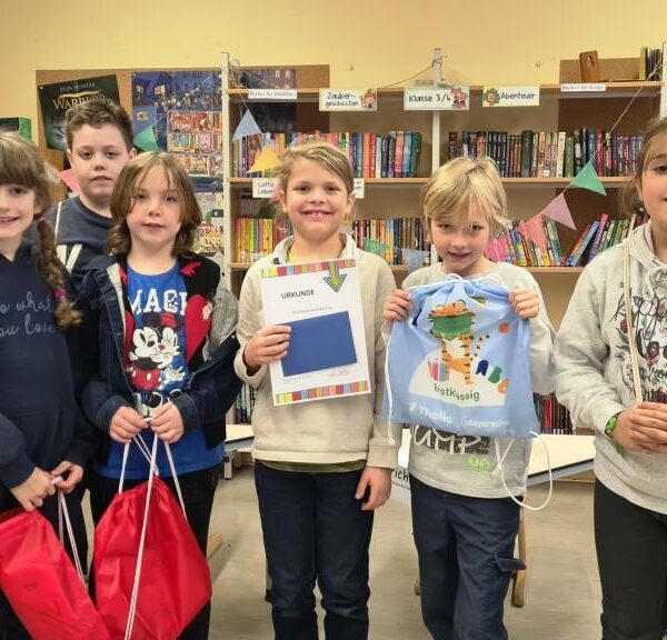 6 Kinder/Teilnehmer des Vorlesewettbewerb der 3. Klassen, ein Kind hält Urkunde in der Hand